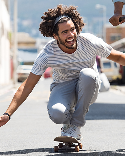 Person in a striped shirt riding a skateboard