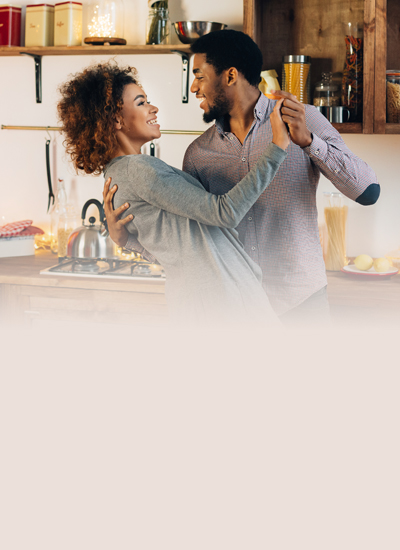 Two people dancing in a kitchen