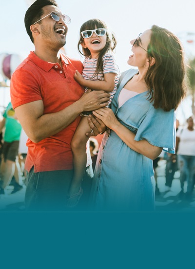 Parents and child wearing sunglasses and smiling