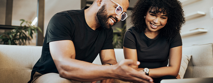 Two people of color smiling together