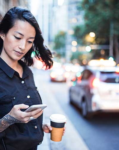 Woman checking mobile phone in the city